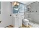 A clean bathroom featuring a sink, toilet, and glass-enclosed shower at 7284 Pebble Beach Ln, Seminole, FL 33777