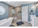 Elegant bathroom featuring a soaking tub, walk-in shower, and dual sinks at 7284 Pebble Beach Ln, Seminole, FL 33777