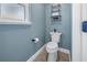 Powder room featuring modern fixtures, a neutral color scheme, and a minimalist design at 7284 Pebble Beach Ln, Seminole, FL 33777