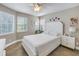 Airy bedroom with white furniture, tile floors, and multiple windows at 7284 Pebble Beach Ln, Seminole, FL 33777