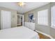 Cozy bedroom with tile floors, a white dresser, and lots of natural light at 7284 Pebble Beach Ln, Seminole, FL 33777