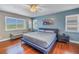 Beautiful bedroom featuring wood floors, ample natural light, and a modern ceiling fan at 7284 Pebble Beach Ln, Seminole, FL 33777