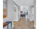 Hallway boasts neutral-colored walls and tiled floors, leading to a spacious living area with natural light at 7284 Pebble Beach Ln, Seminole, FL 33777