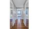 Hallway leading to a bathroom, featuring hardwood floors and mirrored closet doors at 7284 Pebble Beach Ln, Seminole, FL 33777