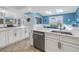 Bright kitchen featuring white cabinetry, stainless steel appliances, and natural light at 7284 Pebble Beach Ln, Seminole, FL 33777