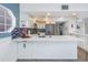 Well-lit kitchen with white cabinetry, stainless steel appliances, and a breakfast bar at 7284 Pebble Beach Ln, Seminole, FL 33777