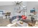 Bright living room with an open layout, vaulted ceiling, and stairs leading to the second floor at 7284 Pebble Beach Ln, Seminole, FL 33777