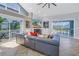 Bright living room featuring vaulted ceilings, tile floors, a fireplace, and access to the outdoor area at 7284 Pebble Beach Ln, Seminole, FL 33777