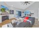 Inviting living room with a vaulted ceiling, modern fireplace, and sliding glass doors to a screened-in porch at 7284 Pebble Beach Ln, Seminole, FL 33777