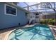 Lovely view of the pristine pool with pool screen and steps for access to the home at 7284 Pebble Beach Ln, Seminole, FL 33777