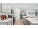 Modern kitchen featuring white countertops, stainless steel appliances, and gray cabinets at 7804 Wheat Stone Dr, Zephyrhills, FL 33540