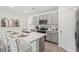 Bright kitchen with white cabinets, stainless steel appliances, and seating at the island at 7804 Wheat Stone Dr, Zephyrhills, FL 33540