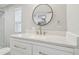 Bathroom featuring a round mirror, vanity and modern sink at 8408 Bob Wiggs Ave, Lithia, FL 33547