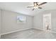 Bright bedroom with gray walls, ceiling fan, and an adjacent bathroom at 8408 Bob Wiggs Ave, Lithia, FL 33547