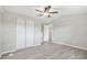 Bright bedroom with gray walls, ceiling fan, and closet at 8408 Bob Wiggs Ave, Lithia, FL 33547