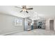 Open concept kitchen with stainless steel appliances and grey cabinets at 8408 Bob Wiggs Ave, Lithia, FL 33547