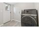 Inside laundry room features modern washer and easy access to the back door at 8408 Bob Wiggs Ave, Lithia, FL 33547