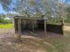 Shed featuring corrugated metal siding and wooden support posts at 8408 Bob Wiggs Ave, Lithia, FL 33547