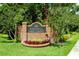 Westchase Golf Course entrance sign with brick base, fresh flowers, manicured landscaping, and mature trees at 8731 Boysenberry Dr, Tampa, FL 33635