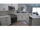 Modern kitchen featuring stainless steel appliances, white cabinetry, quartz counters, and a stylish backsplash at 8731 Boysenberry Dr, Tampa, FL 33635