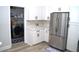 Modern kitchen area, stainless steel appliances, washer/dryer, and white cabinets at 8731 Boysenberry Dr, Tampa, FL 33635