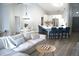 Bright living room featuring cathedral ceilings, modern decor, and an adjacent kitchen island with bar seating at 8731 Boysenberry Dr, Tampa, FL 33635