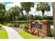 Well-maintained swim and tennis center sign, enhanced by vibrant landscaping at 8731 Boysenberry Dr, Tampa, FL 33635