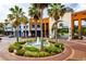 Charming town center features a central fountain surrounded by colorful buildings and lush palm trees at 8731 Boysenberry Dr, Tampa, FL 33635