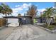 Exterior view of a home featuring a boat, ample parking, and neutral exterior paint at 939 Mandalay Ave, Clearwater Beach, FL 33767