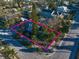 Aerial view of a charming property showcasing mature trees and a well-maintained yard on a corner lot at 939 Mandalay Ave, Clearwater Beach, FL 33767