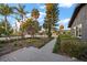 A walkway leading to a charming home with lush landscaping and mature trees at 939 Mandalay Ave, Clearwater Beach, FL 33767