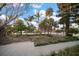 Serene home exterior with a lush, verdant front yard complemented by surrounding mature trees and plants at 939 Mandalay Ave, Clearwater Beach, FL 33767