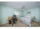 Bright bedroom featuring a ceiling fan, neutral carpet, and home office desk with chair at 9940 69Th N St, Pinellas Park, FL 33782