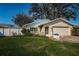 Charming single-story home featuring a well-manicured lawn and a two-car garage at 9940 69Th N St, Pinellas Park, FL 33782