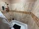 Well-lit bathroom featuring a shower with stylish tile surround and modern fixtures at 13915 Village View Dr, Tampa, FL 33624