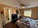 Cozy bedroom with ceiling fan, closet, natural light from the window and bathroom access at 13915 Village View Dr, Tampa, FL 33624