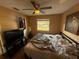 Cozy bedroom with ceiling fan, closet, natural light from the window and tv console at 13915 Village View Dr, Tampa, FL 33624