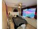 Bedroom featuring a ceiling fan, unique wall decor, and ample natural light at 13915 Village View Dr, Tampa, FL 33624