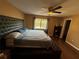 Comfortable bedroom featuring a large bed, ceiling fan, and lots of natural light at 13915 Village View Dr, Tampa, FL 33624