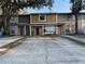 Exterior view of townhomes with mature trees and ample parking at 13915 Village View Dr, Tampa, FL 33624