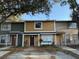 Charming two-story townhome featuring a well-kept exterior and lovely landscaping at 13915 Village View Dr, Tampa, FL 33624