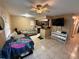 Open-concept living space featuring a modern kitchen, comfortable seating, and tile flooring at 13915 Village View Dr, Tampa, FL 33624