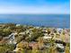 Aerial view of homes in a waterfront community with boat docks, mature trees, and lovely landscaping at 140 Sage Cir, Crystal Beach, FL 34681