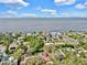 Panoramic aerial shot of a waterfront residential area boasting lush trees, lovely homes, and scenic ocean view at 140 Sage Cir, Crystal Beach, FL 34681
