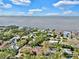 Aerial view of homes in a waterfront community with boat docks, mature trees, and lovely landscaping at 140 Sage Cir, Crystal Beach, FL 34681