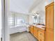 Well-lit bathroom features double sinks, a soaking tub with glass block window, and tiled floors at 140 Sage Cir, Crystal Beach, FL 34681