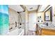 Charming bathroom featuring a vanity with granite countertop, a tile shower, and neutral color palette at 140 Sage Cir, Crystal Beach, FL 34681