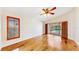Well-lit bedroom with hardwood floors, window with blinds, and access to an enclosed screened-in porch at 140 Sage Cir, Crystal Beach, FL 34681