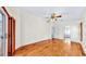 Bright bedroom with hardwood floors, neutral walls, and sliding glass doors with wooden shutters at 140 Sage Cir, Crystal Beach, FL 34681