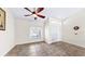 Neutral bedroom with tile flooring, a ceiling fan, a window with blinds, and a double door closet at 140 Sage Cir, Crystal Beach, FL 34681